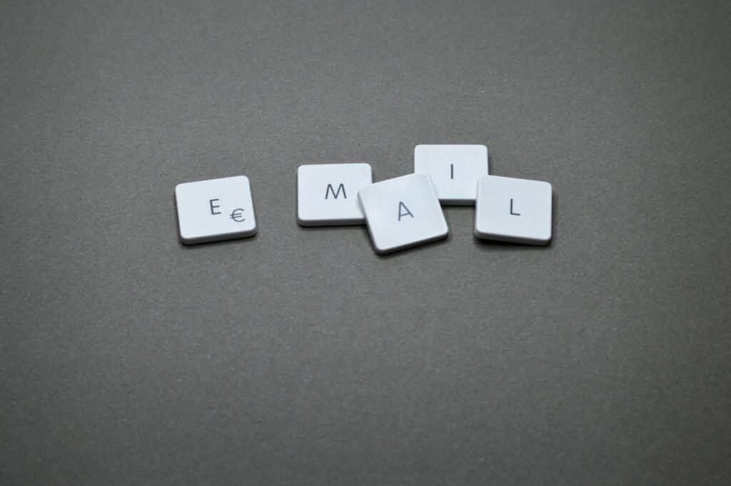 Letter tiles spelling the word EMAIL on a grey background