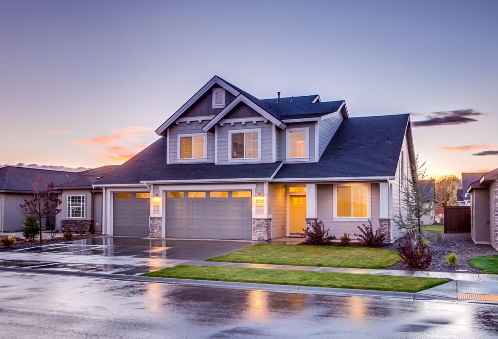 Modern two-storey home exterior at dusk with warm lights on
